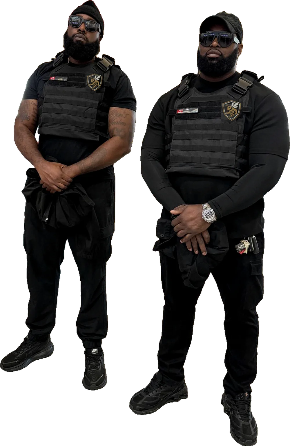 The two owners of Swarm Protective Services in black tactical vests with the Swarm emblem.